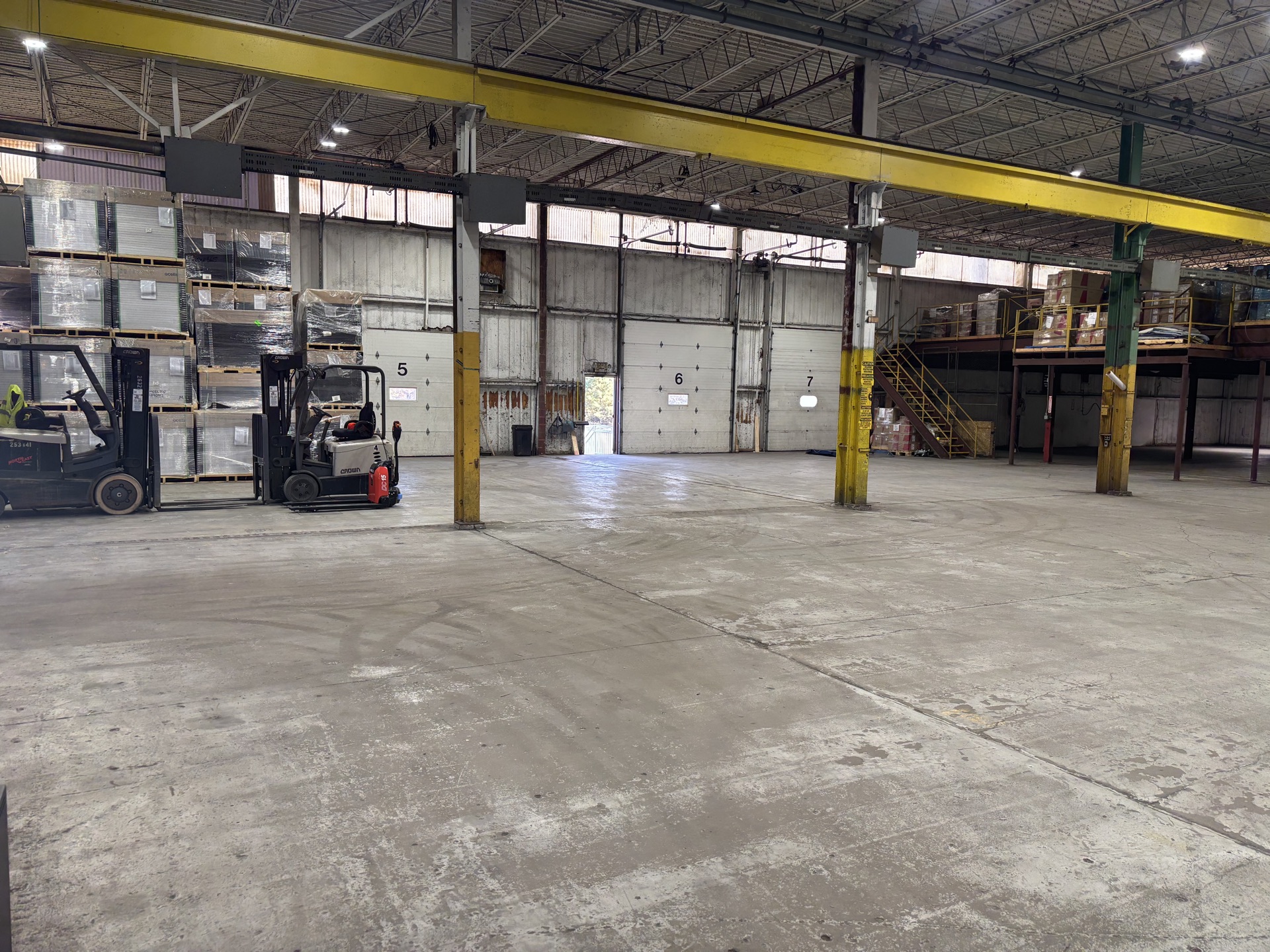 Forklifts and pallets staged on the T2G dock floor in Millville, NJ — freight ready to move dock-to-dock